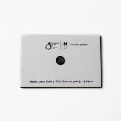 The back of a wooden magnet with Matija Jama's Kolo motif on a white background.