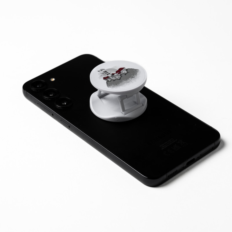White phone holder with an illustration of Ljubljana Castle on the back of a black phone