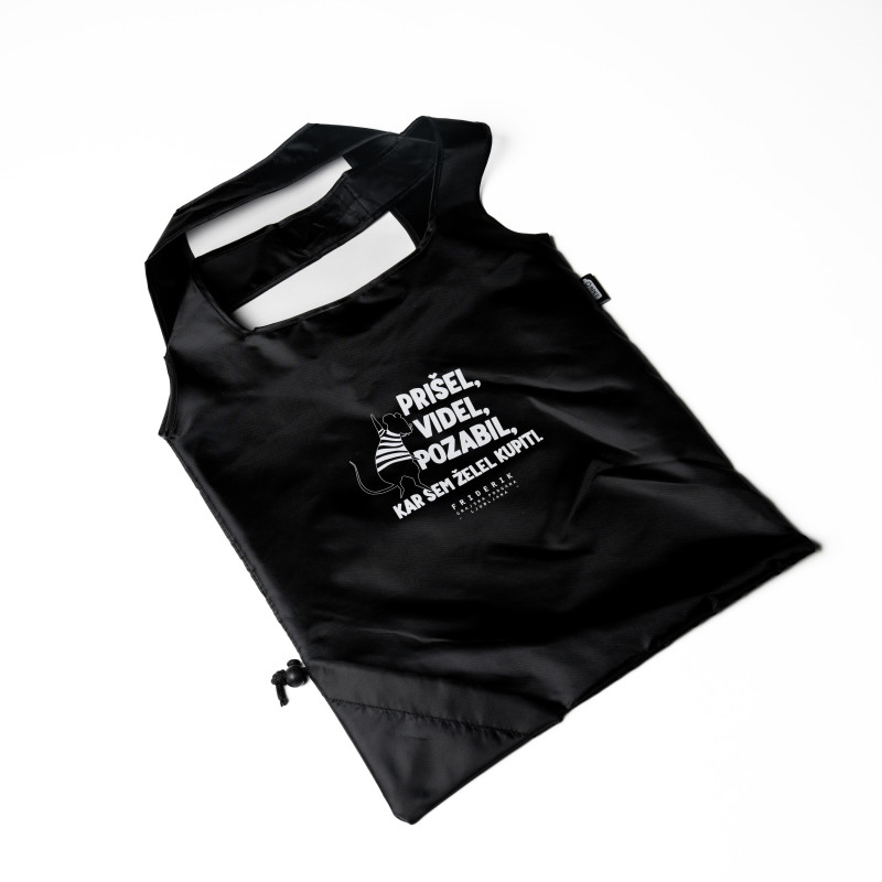 Razgrnjena črna nakupovalna vrečka z belim napisom v slovenščini.